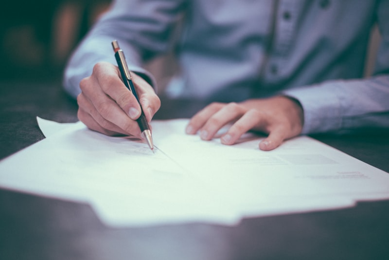 Man signing an offer document